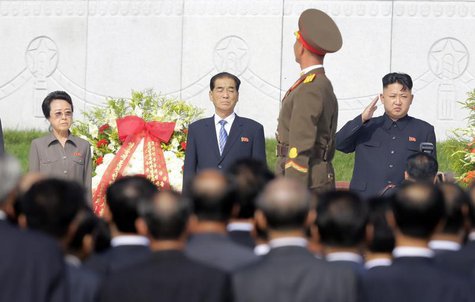 North Korean leader Kim Jong-un (R) salutes as a honour guard march past as he and his aunt Kim Kyong-hui (L), Premier Pak Pong-ju attend th North Korean leader Kim Jong-un (R) salutes as a honour guard march past as he and his aunt Kim Kyong-hui (L), Premier Pak Pong-ju attend th