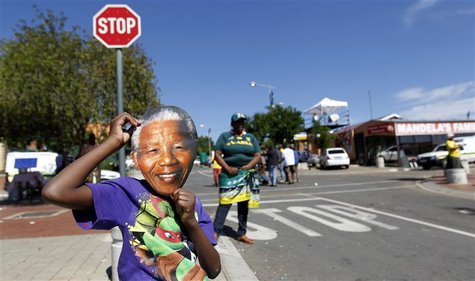 A boy wears a mask of former South African President Nelson Mandela outside his house along Vilakazi Street in Soweto, where Mandela resided A boy wears a mask of former South African President Nelson Mandela outside his house along Vilakazi Street in Soweto, where Mandela resided