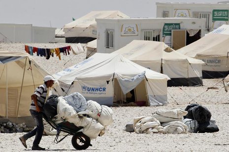 A newly arrived Syrian refugee receives aid and rations, at Al-Zaatri refugee camp in the Jordanian city of Mafraq, near the border with Syr A newly arrived Syrian refugee receives aid and rations, at Al-Zaatri refugee camp in the Jordanian city of Mafraq, near the border with Syr