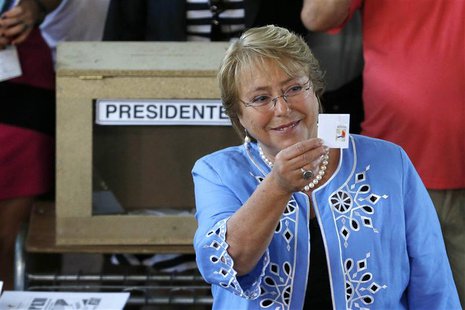 Chilean presidential candidate Michelle Bachelet shows her ballot paper during the presidential election in Santiago December 15, 2013. REUT Chilean presidential candidate Michelle Bachelet shows her ballot paper during the presidential election in Santiago December 15, 2013. REUT