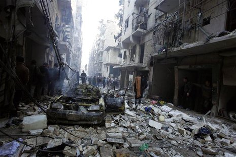 Residents look for survivors at a damaged site after what activists said was an air strike from forces loyal to Syria's President Bashar al- Residents look for survivors at a damaged site after what activists said was an air strike from forces loyal to Syria's President Bashar al-