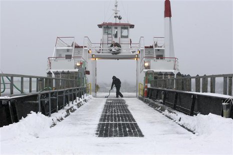 Casco Bay Lines deckhand Nick Ferrara shovels off the deck of the car ferry Machigonne II following a snowstorm in Portland, Maine December Casco Bay Lines deckhand Nick Ferrara shovels off the deck of the car ferry Machigonne II following a snowstorm in Portland, Maine December