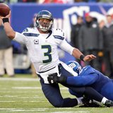 Dec 15, 2013; East Rutherford, NJ, USA; Seattle Seahawks quarterback Russell Wilson (3) throws a pass as he is taken down by New York Giants Dec 15, 2013; East Rutherford, NJ, USA; Seattle Seahawks quarterback Russell Wilson (3) throws a pass as he is taken down by New York Giants