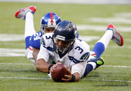 Dec 15, 2013; East Rutherford, NJ, USA; Seattle Seahawks quarterback Russell Wilson (3) dives forward for a first down as New York Giants co Dec 15, 2013; East Rutherford, NJ, USA; Seattle Seahawks quarterback Russell Wilson (3) dives forward for a first down as New York Giants co