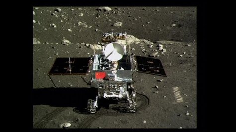 A view of China's first moon rover, Yutu, or Jade Rabbit, is seen on the lunar surface with the Chinese national flag in this still image ta A view of China's first moon rover, Yutu, or Jade Rabbit, is seen on the lunar surface with the Chinese national flag in this still image ta