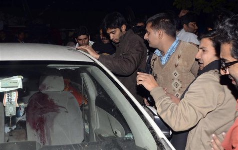 Men stand next to a damaged car of Allama Nasir Abbas, a leader of Tehreek Nifaz Fiqah-e-Jafaria, a banned Shi'ite organisation, after he wa Men stand next to a damaged car of Allama Nasir Abbas, a leader of Tehreek Nifaz Fiqah-e-Jafaria, a banned Shi'ite organisation, after he wa