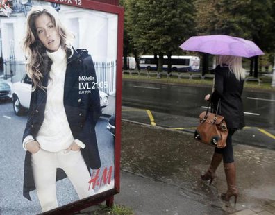 A woman walks past a H&M advertisement in Riga September 25, 2013. REUTERS/Ints Kalnins A woman walks past a H&M advertisement in Riga September 25, 2013. REUTERS/Ints Kalnins
