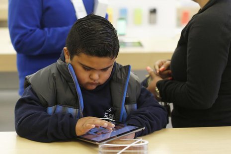 A child uses an iPad Air tablet at the Apple store in San Francisco, California November 1, 2013. REUTERS/Stephen Lam A child uses an iPad Air tablet at the Apple store in San Francisco, California November 1, 2013. REUTERS/Stephen Lam