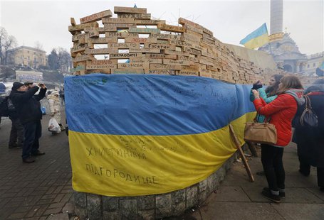 People take pictures of wooden bars, bearing names of Ukrainian cities and settlements which are hometowns of demonstrators, as Pro-European People take pictures of wooden bars, bearing names of Ukrainian cities and settlements which are hometowns of demonstrators, as Pro-European