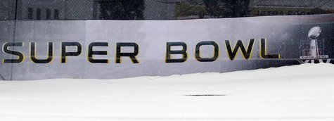 A snow bank obscures the logo for Super Bowl XLV outside Cowboy Stadium in Arlington, Texas February 4, 2011. REUTERS/Brian Snyder A snow bank obscures the logo for Super Bowl XLV outside Cowboy Stadium in Arlington, Texas February 4, 2011. REUTERS/Brian Snyder