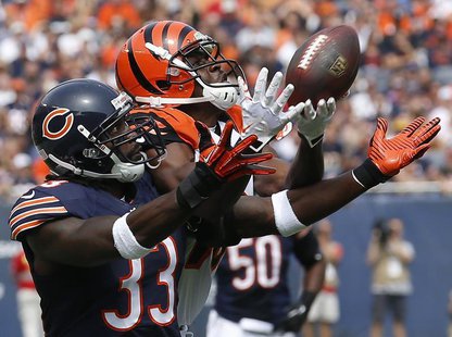 Cincinnati Bengals' Andrew Hawkins (R) makes a catch against Chicago Bears' Charles Tillman during the first quarter of their NFL football g Cincinnati Bengals' Andrew Hawkins (R) makes a catch against Chicago Bears' Charles Tillman during the first quarter of their NFL football g