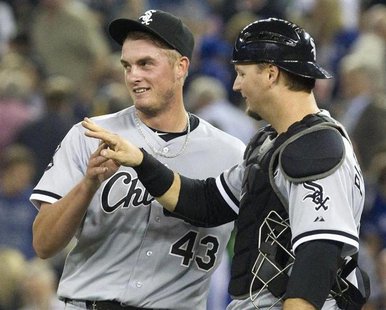 Chicago White Sox catcher A.J. Pierzynski (R) congratulates pitcher Addison Reed on the save after they beat the Toronto Blue Jays in their Chicago White Sox catcher A.J. Pierzynski (R) congratulates pitcher Addison Reed on the save after they beat the Toronto Blue Jays in their