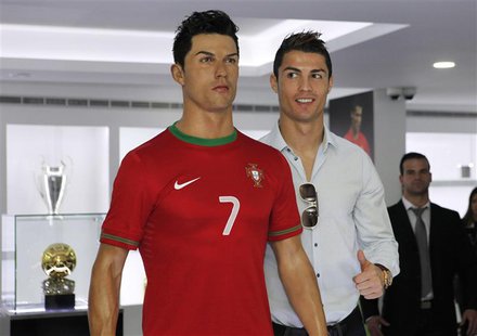 Cristiano Ronaldo, who plays for Real Madrid and Portugal's national soccer team, poses with his statue during the inauguration of his museu Cristiano Ronaldo, who plays for Real Madrid and Portugal's national soccer team, poses with his statue during the inauguration of his museu