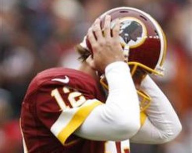 Washington Redskins quarterback Kirk Cousins listens for a play call from the sidelines on a receiver in his helmet during the second half of their NFL football game against the Atlanta Falcons in Landover, Maryland, October 7, 2012.
REUTERS/Jonathan Ernst Washington Redskins quarterback Kirk Cousins listens for a play call from the sidelines on a receiver in his helmet during the second half of their NFL football game against the Atlanta Falcons in Landover, Maryland, October 7, 2012.
REUTERS/Jonathan Ernst