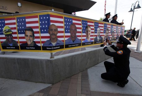 San Diego firefighter Robert Bunsoldat takes a picture of each of the Prescott Fire Department's Granite Mountain Hotshots team from a banne San Diego firefighter Robert Bunsoldat takes a picture of each of the Prescott Fire Department's Granite Mountain Hotshots team from a banne