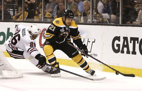 Boston Bruins right wing Shawn Thornton (22) is chased by Chicago Blackhawks center Michal Handzus (26) during the first period in Game 3 of Boston Bruins right wing Shawn Thornton (22) is chased by Chicago Blackhawks center Michal Handzus (26) during the first period in Game 3 of