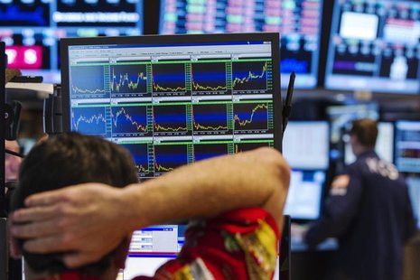 A trader rubs his head as he looks up at informational screens while working on the floor of the New York Stock Exchange shortly before the A trader rubs his head as he looks up at informational screens while working on the floor of the New York Stock Exchange shortly before the
