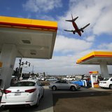 Consumers purchase gasoline at a gas station as a plane approaches to land at the airport in San Diego, California October 8, 2012. REUTERS/ Consumers purchase gasoline at a gas station as a plane approaches to land at the airport in San Diego, California October 8, 2012. REUTERS/