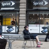 People talk on their cell phones as passers-by walk past a Sprint store in New York, October 15, 2012. REUTERS/Keith Bedford People talk on their cell phones as passers-by walk past a Sprint store in New York, October 15, 2012. REUTERS/Keith Bedford