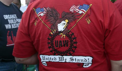 A United Auto Workers union member wears a shirt with 'UAW United We Stand' on it during a ceremony where members of UAW Local 600 unfurled A United Auto Workers union member wears a shirt with 'UAW United We Stand' on it during a ceremony where members of UAW Local 600 unfurled