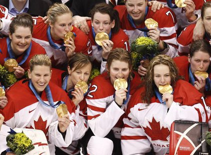 Canadian hockey team members pose with their gold medals after defeating the U.S. in their gold medal ice hockey game at the Vancouver 2010 Canadian hockey team members pose with their gold medals after defeating the U.S. in their gold medal ice hockey game at the Vancouver 2010