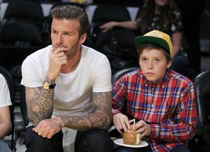 Soccer star David Beckham (L) and his son Brooklyn watch the Los Angeles Lakers play the Miami Heat in their NBA basketball game in Los Ange Soccer star David Beckham (L) and his son Brooklyn watch the Los Angeles Lakers play the Miami Heat in their NBA basketball game in Los Ange
