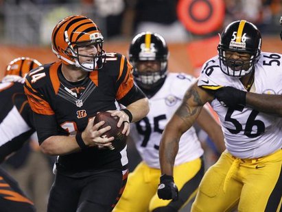 Cincinnati Bengals quarterback Andy Dalton (14) throws under pressure from the Pittsburgh Steelers' LaMarr Woodley (56) and Jarvis Jones (95 Cincinnati Bengals quarterback Andy Dalton (14) throws under pressure from the Pittsburgh Steelers' LaMarr Woodley (56) and Jarvis Jones (95