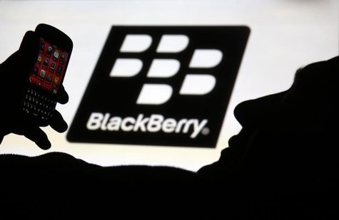 A man is silhouetted against a video screen with the Blackberry logo as he pose with a Blackberry Q10 in this photo illustration taken in th A man is silhouetted against a video screen with the Blackberry logo as he pose with a Blackberry Q10 in this photo illustration taken in th