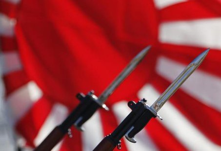 Bayonets attached to rifles used by Japanese Self-Defense Forces are seen in front of Japan's rising sun flag, which is used by the forces, during the annual troop review ceremony at Asaka Base in Asaka, near Tokyo October 27, 2013.
CREDIT: REUTERS/ISSEI KATO Bayonets attached to rifles used by Japanese Self-Defense Forces are seen in front of Japan's rising sun flag, which is used by the forces, during the annual troop review ceremony at Asaka Base in Asaka, near Tokyo October 27, 2013.
CREDIT: REUTERS/ISSEI KATO