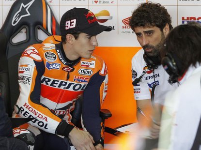 Honda MotoGP rider Marc Marquez (L) of Spain listens to technicians before the first free practice session ahead the Valencia Motorcycle Gra Honda MotoGP rider Marc Marquez (L) of Spain listens to technicians before the first free practice session ahead the Valencia Motorcycle Gra