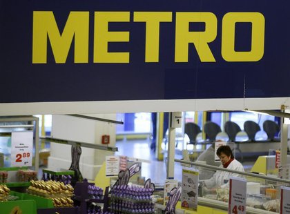 A cashier works at one of the top three cash and carry markets of Metro AG in Sankt Augustin near Bonn March 18, 2013. REUTERS/Wolfgang Ratt A cashier works at one of the top three cash and carry markets of Metro AG in Sankt Augustin near Bonn March 18, 2013. REUTERS/Wolfgang Ratt