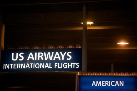US Airways and American Airlines signs are pictured at Philadelphia International Airport in Philadelphia, Pennsylvania on December 9, 2013. US Airways and American Airlines signs are pictured at Philadelphia International Airport in Philadelphia, Pennsylvania on December 9, 2013.
