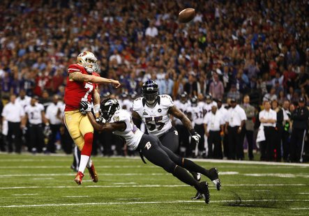San Francisco 49ers quarterback Colin Kaepernick (L) throws under pressure from Baltimore Ravens free safety Ed Reed during the first quarte San Francisco 49ers quarterback Colin Kaepernick (L) throws under pressure from Baltimore Ravens free safety Ed Reed during the first quarte