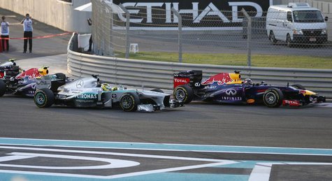 Red Bull Formula One driver Sebastian Vettel of Germany (R) drives ahead of Mercedes Formula One driver Nico Rosberg of Germany and Red Bull Red Bull Formula One driver Sebastian Vettel of Germany (R) drives ahead of Mercedes Formula One driver Nico Rosberg of Germany and Red Bull