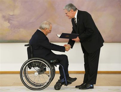 Wolfgang Schaeuble (L) receives his certificate of appointment as Finance Minister from President Joachim Gauck during a ceremony in the Bel Wolfgang Schaeuble (L) receives his certificate of appointment as Finance Minister from President Joachim Gauck during a ceremony in the Bel