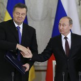 Russia's President Vladimir Putin (R) shakes hands with his Ukrainian counterpart Viktor Yanukovich during a signing ceremony after a meetin Russia's President Vladimir Putin (R) shakes hands with his Ukrainian counterpart Viktor Yanukovich during a signing ceremony after a meetin