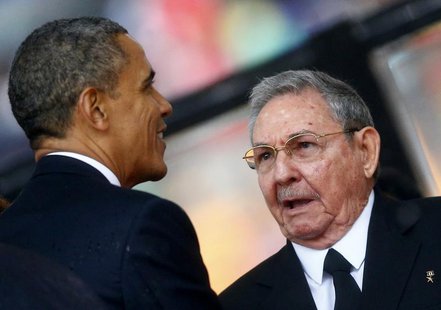 U.S. President Barack Obama (L) greets Cuban President Raul Castro before giving his speech at the memorial service for late South African P U.S. President Barack Obama (L) greets Cuban President Raul Castro before giving his speech at the memorial service for late South African P