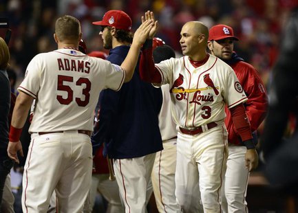 St. Louis Cardinals right fielder Carlos Beltran (3) celebrates with first baseman Matt Adams (53) after defeating the Boston Red Sox in gam St. Louis Cardinals right fielder Carlos Beltran (3) celebrates with first baseman Matt Adams (53) after defeating the Boston Red Sox in gam