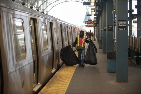 A custodian carries bags of garbage as New York City subway trains stop at the Coney Island station prior to a total subway shutdown at 7pm A custodian carries bags of garbage as New York City subway trains stop at the Coney Island station prior to a total subway shutdown at 7pm
