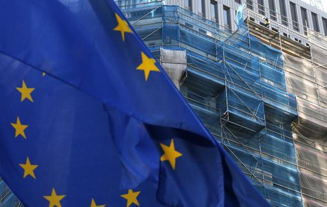 A European Union flag flutters as a construction worker is seen on a building under renovation in Brussels December 9, 2013. REUTERS/Francoi A European Union flag flutters as a construction worker is seen on a building under renovation in Brussels December 9, 2013. REUTERS/Francoi