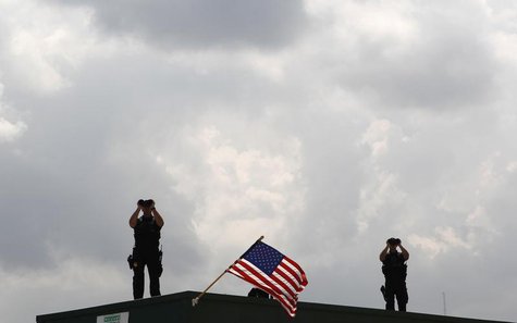 U.S. Secret Service personnel provide security for President Barack Obama as he tours Theodore Staging Facility to learn about recent develo U.S. Secret Service personnel provide security for President Barack Obama as he tours Theodore Staging Facility to learn about recent develo