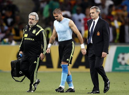 Spain's goalkeeper Victor Valdes (C) is escorted off the field during their international friendly soccer match against South Africa at Socc Spain's goalkeeper Victor Valdes (C) is escorted off the field during their international friendly soccer match against South Africa at Socc