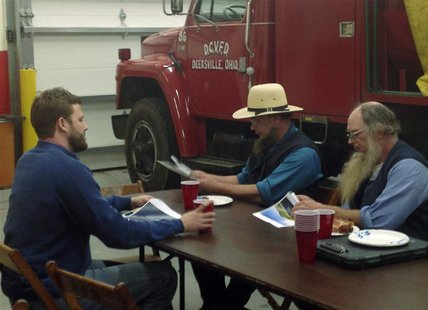 Austin Eudaly (L), an executive with Flatiron Energy Partners, talks with members of the Ohio Amish community at the Deersville, Ohio, Volun Austin Eudaly (L), an executive with Flatiron Energy Partners, talks with members of the Ohio Amish community at the Deersville, Ohio, Volun