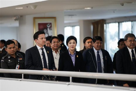 Thailand's Prime Minister Yingluck Shinawatra (C) leaves the Government Complex after a meeting with the Election Commission in Bangkok Dece Thailand's Prime Minister Yingluck Shinawatra (C) leaves the Government Complex after a meeting with the Election Commission in Bangkok Dece