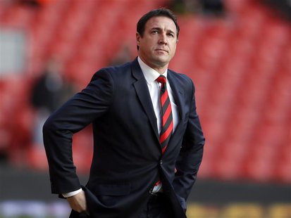 Cardiff City's manager Malky Mackay walks onto the pitch before their English Premier League soccer match against Liverpool at Anfield in Li Cardiff City's manager Malky Mackay walks onto the pitch before their English Premier League soccer match against Liverpool at Anfield in Li