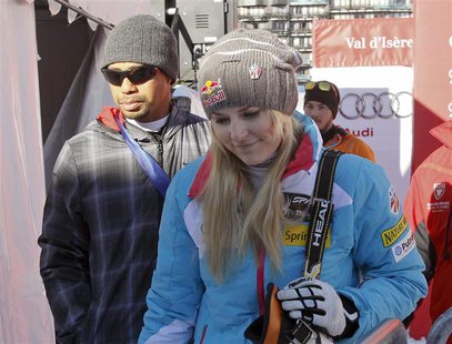 Lindsey Vonn (front R) of the U.S. and her boyfriend, golfer Tiger Woods leave after the Women's World Cup Downhill skiing race in Val d'Ise Lindsey Vonn (front R) of the U.S. and her boyfriend, golfer Tiger Woods leave after the Women's World Cup Downhill skiing race in Val d'Ise