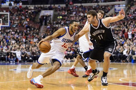 Dec 20, 2013; Philadelphia, PA, USA; Philadelphia 76ers guard Evan Turner (12) is defended by Brooklyn Nets center Brook Lopez (11) during t Dec 20, 2013; Philadelphia, PA, USA; Philadelphia 76ers guard Evan Turner (12) is defended by Brooklyn Nets center Brook Lopez (11) during t