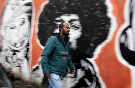 Director Dagmawi Yimer from Ethiopia walks past a mural in downtown Rome November 13, 2013. REUTERS/Tony Gentile Director Dagmawi Yimer from Ethiopia walks past a mural in downtown Rome November 13, 2013. REUTERS/Tony Gentile