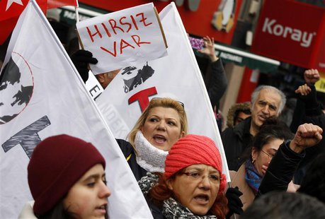 A woman holds a sign that reads "There is a thief" as protesters demonstrate against Turkey's ruling Ak Party (AKP) and Prime Minister Tayyi A woman holds a sign that reads "There is a thief" as protesters demonstrate against Turkey's ruling Ak Party (AKP) and Prime Minister Tayyi