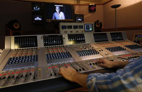 Opera Singer Angela Denoke playing the role of Kundry appears on a screen in the sound room during a live broadcast of the opera "Parsifal" Opera Singer Angela Denoke playing the role of Kundry appears on a screen in the sound room during a live broadcast of the opera "Parsifal"